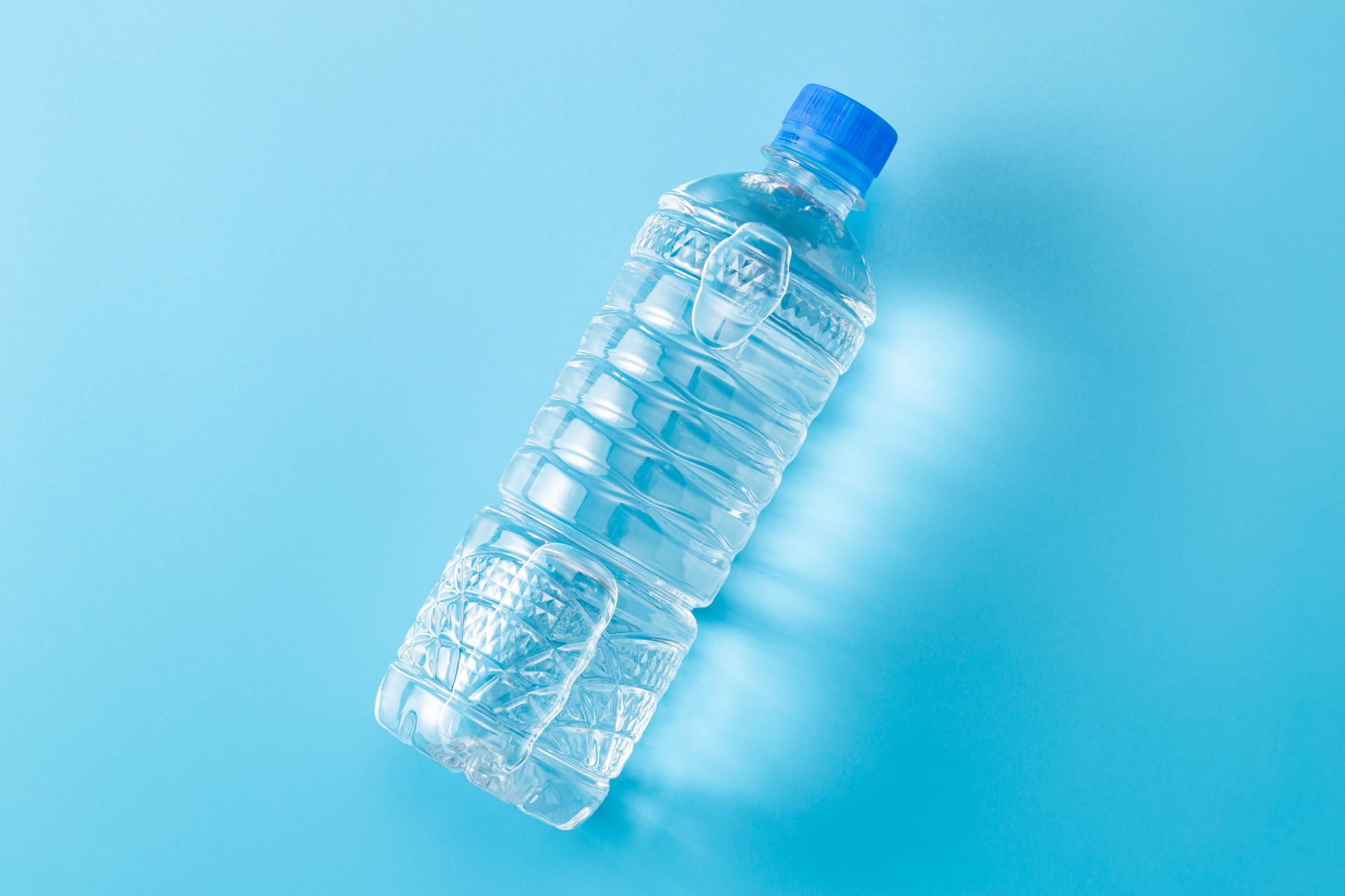 Bottled water on blue background.